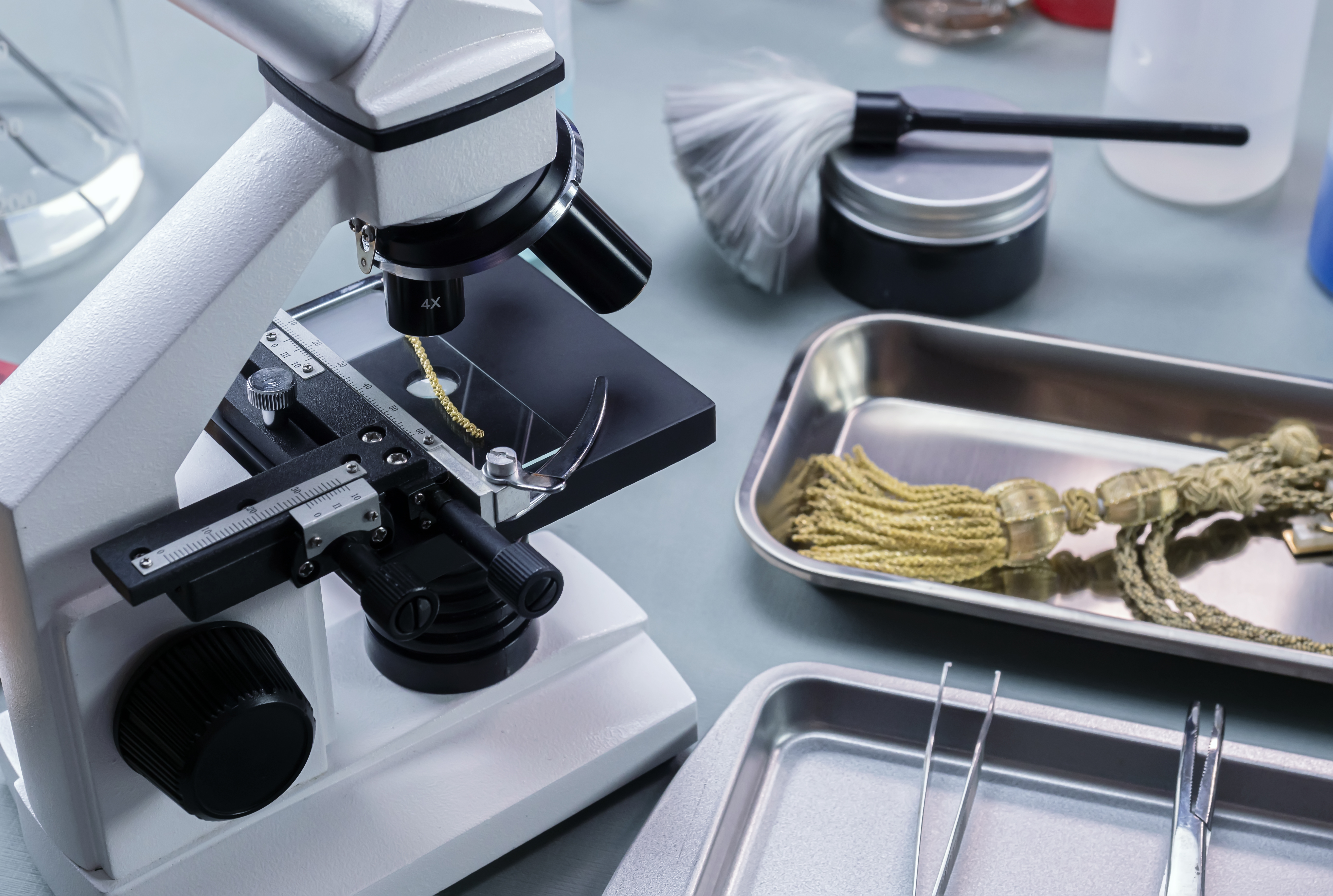 golden cord under a microscope analysed in a crime lab, concept image