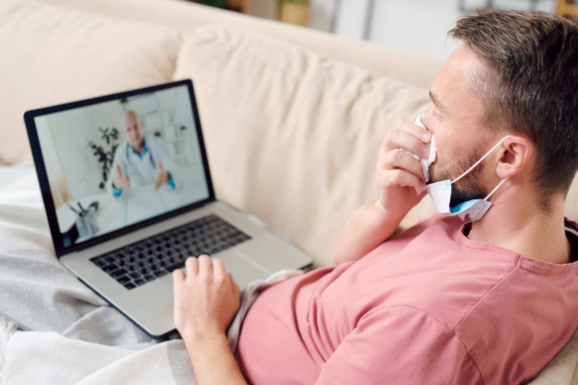 young sick man with laptop blowing his nose while 2025 03 15 07 52 33 utc.jpg
